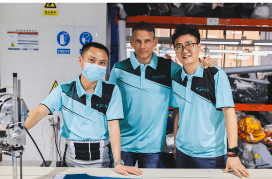 Sam Clay and Eric Fan with employee in Sphere Sport China factory